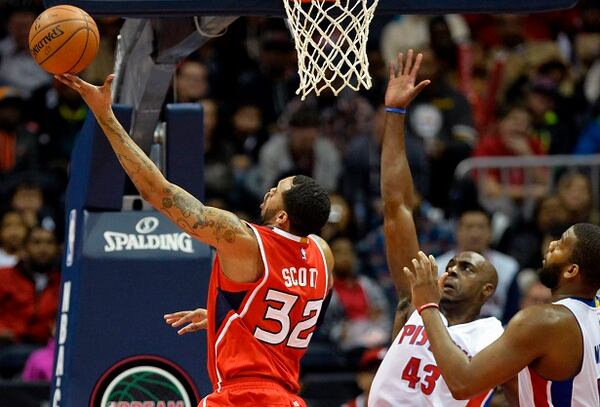 Atlanta Hawks' Mike Scott (32) shoots a layup around Detroit Pistons' Anthony Tolliver (43) and Greg Monroe, right, in the second half of an NBA basketball game Monday, Jan. 19, 2015, in Atlanta. Atlanta won 93-82. (AP Photo/David Tulis) Mike Scott for two of his 20. (David Tulis/AP photo)