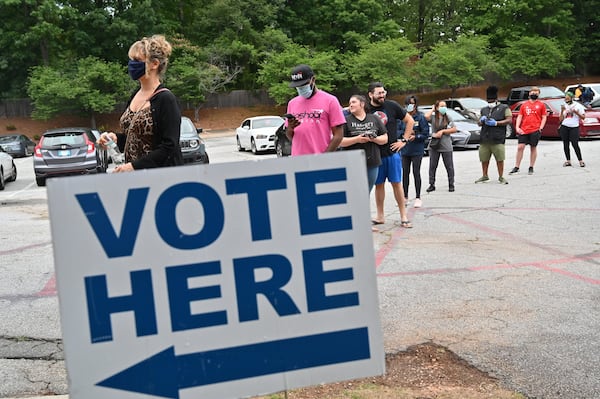 DeKalb County residents wait outside Ray Hope Christian Church in Decatur to cast their votes in the Georgia primary after 7 p.m. Tuesday, the original poll closing time. (Hyosub Shin / Hyosub.Shin@ajc.com)