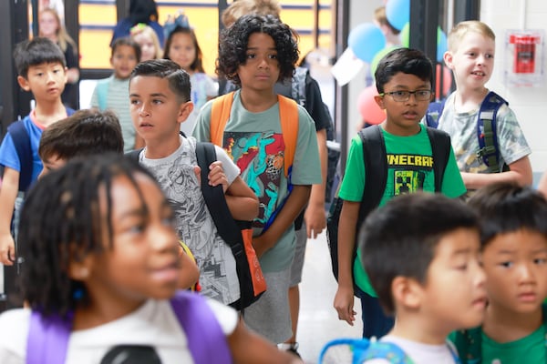 Students arrive at Harmony Elementary School in Buford for the first day of school on Wednesday, Aug. 2, 2023. (Natrice Miller/ Natrice.miller@ajc.com)