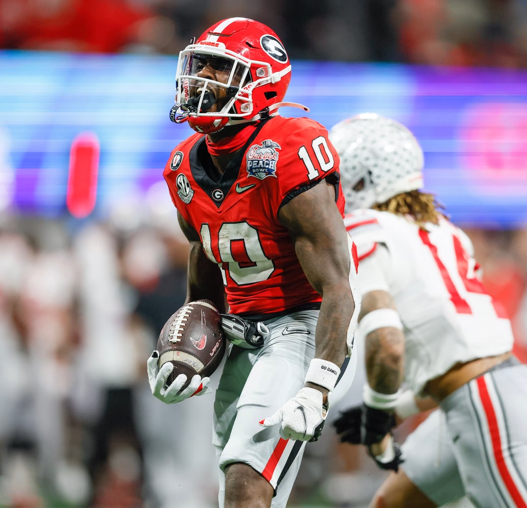 Georgia Bulldogs wide receiver Kearis Jackson (10) celebrates after completing a 35 yard pass for a first down to set up Georgia's go ahead score during the fourth quarter of the College Football Playoff Semifinal between the Georgia Bulldogs and the Ohio State Buckeyes at the Chick-fil-A Peach Bowl In Atlanta on Saturday, Dec. 31, 2022.  Georgia won, 42-41. (Jason Getz / Jason.Getz@ajc.com)