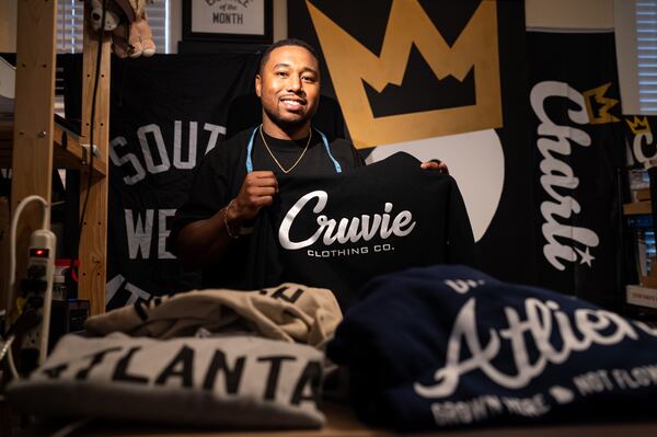 Tony Cruver, who founded Cruvie Clothing in 2013, poses at his home workspace in West End. (Seeger Gray / AJC)