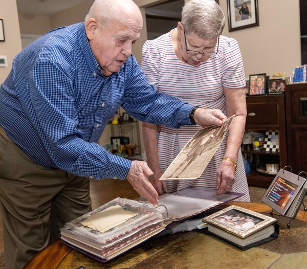 Holocaust survivor Hershel Greenblat and his wife Rochelle look through old family photos in his home in Grayson, Georgia. PHIL SKINNER FOR THE ATLANTA JOURNAL-CONSTITUTION