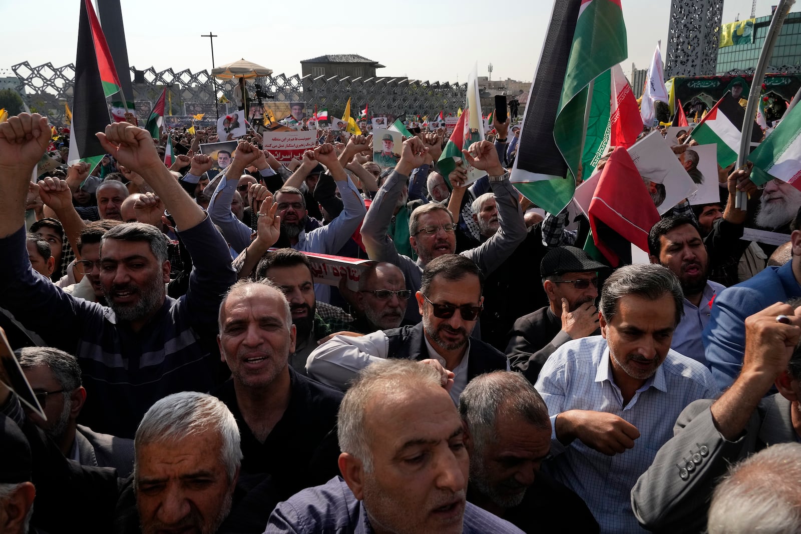 People chant slogans during the funeral ceremony of the late Iranian Revolutionary Guard Gen. Abbas Nilforushan, who was killed in an Israeli airstrike in Beirut in late September, in Tehran, Iran, Tuesday, Oct. 15, 2024. (AP Photo/Vahid Salemi)