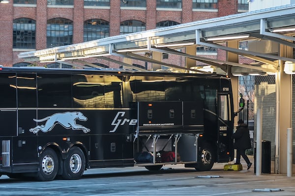 Passengers board a Greyhound bus outside the Forsyth Street station in downtown Atlanta on Friday morning.