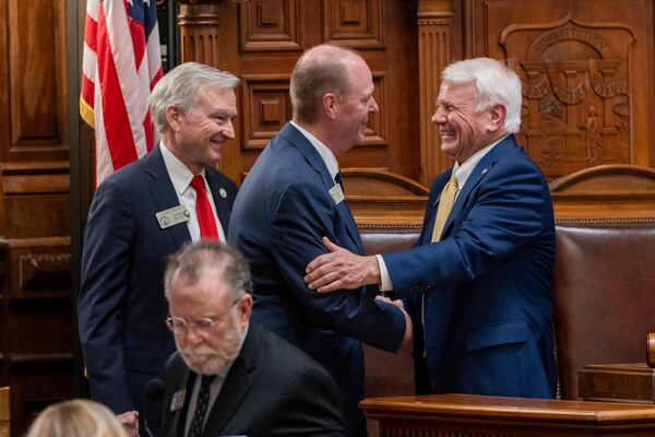 Rep. Holt Persinger, center, R-Winder, shakes hands with House Speaker Jon Burns, R-Newington, following the passage of the school safety bill Persinger sponsored, HB 268, at the House in the Capitol in Atlanta on Tuesday, March 4, 2025. (Arvin TemkarAtlanta Journal-Constitution via AP)