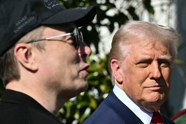 President Donald Trump and Tesla CEO Elon Musk talk with to reporters near Tesla vehicles on the South Lawn of the White House Tuesday, March 11, 2025, in Washington. (Pool via AP)