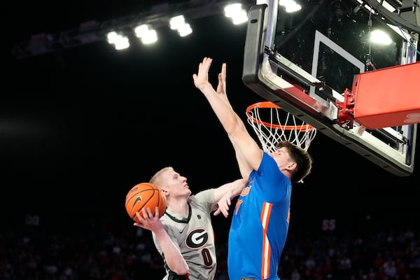 Georgia guard Blue Cain (0) shoots against Florida forward Alex Condon (21) during an NCAA college basketball game, Tuesday, Feb. 25, 2025, in Athens, Ga. (AP Photo/Brynn Anderson)