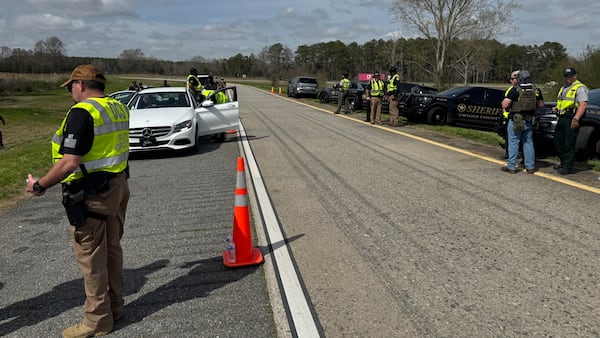 Sheriff's deputies, police officers and Georgia State Patrol troopers, among other law enforcement officials, oversee the annual Operation Wrong Exit in Twiggs County. The I-16 checkpoint aims to curtail drunken driving, seatbelt violations and other infractions. (Joe Kovac Jr. / AJC)