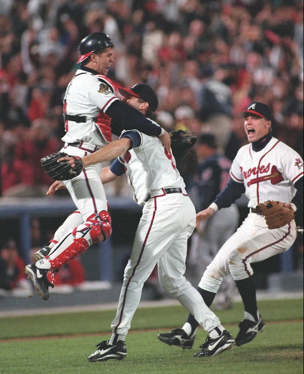 Javier Lopez leaps into the arms of Mark Wohlers after the last out of the 1995 World Series, Saturday, October 28, 1995. Chipper Jones is at right. It was the only World Series won by the Braves, whose unprecedented 14 consecutive years of first place finishes is the subject of a new book (AJC photo/Frank Niemeir)