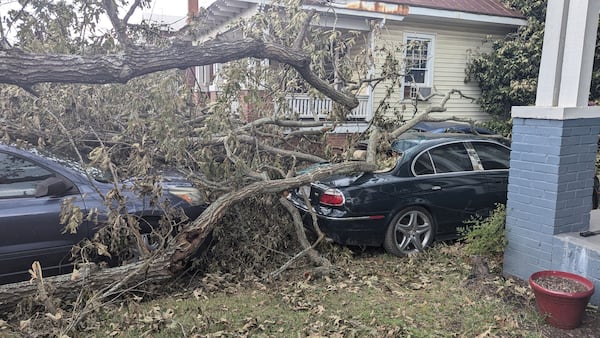 An oak tree limb fell on top of two of Qena Fabin's cars, preventing her from leaving her neighborhood in Augusta, Ga., on Sunday, Sept. 29, 2024. (Mirtha Donastorg/AJC)