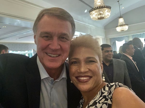 Kaaryn Walker and U.S. Senator David Perdue of Georgia pose for a selfie at the Georgia GOP convention this summer.