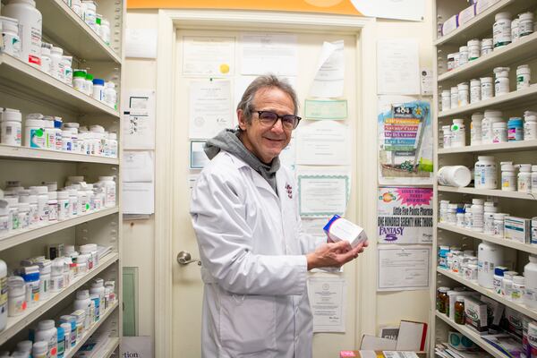 In this file photo, pharmacist Ira Katz poses for a portrait with Paxlovid. CHRISTINA MATACOTTA FOR THE ATLANTA JOURNAL-CONSTITUTION.