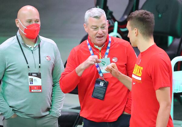 Hawks guard Bogan Bogdanovic gives owner Tony Ressler a fist bump with general manager and president Travis Schlenk before playing the Milwaukee Bucks in game 2 of the NBA Eastern Conference Finals on Friday, June 25, 2021, in Milwaukee.   “Curtis Compton / Curtis.Compton@ajc.com”