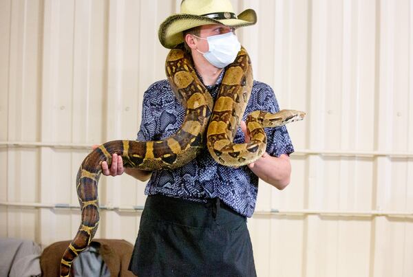 Brandon Barry from Cool Zoo holds a Colombian boa constrictor during the reptile show Repticon Atlanta at the Gwinnett County Fairgrounds on Sunday, January 10, 2021. (Photo: Steve Schaefer for The Atlanta Journal-Constitution)