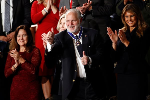 Rush Limbaugh reacts after first Lady Melania Trump presented him with the the Presidential Medal of Freedom as President Donald Trump delivers his State of the Union address to a joint session of Congress on Capitol Hill in Washington, Tuesday, Feb. 4, 2020. Second lady Karen Pence is at left and Kathryn Limbaugh is partially hidden. (AP Photo/Patrick Semansky)