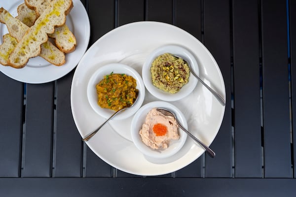 The Dips Trio features, clockwise from left, grilled eggplant dip mirza ghasemi, pea and pistachio hummus, and salmon-based taramasalada, the standout of the bunch. Courtesy of Dara Paryas