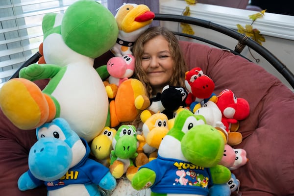 Alaya Horne, age 12, shows off her vast display of Yoshi stuffed animals that she plans to donate to patients at the Children's Hospital on Wednesday, Nov. 22, 2023 in Johns Creek, Georgia. "If I was sick or hurt in the hospital and someone gave me Yoshi, I would be all better," she says when asked why she decided to donate her collection. (Olivia Bowdoin for the Atlanta Journal-Constitution). 