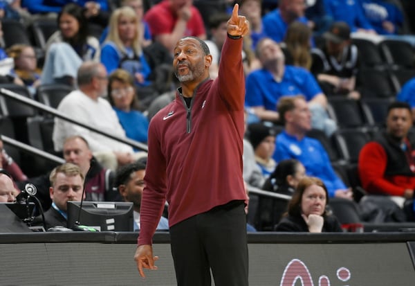 Montana head coach Travis DeCuire directs his team against Wisconsin during the first half in the first round of the NCAA college basketball tournament Thursday, March 20, 2025, in Denver. (AP Photo/John Leyba)