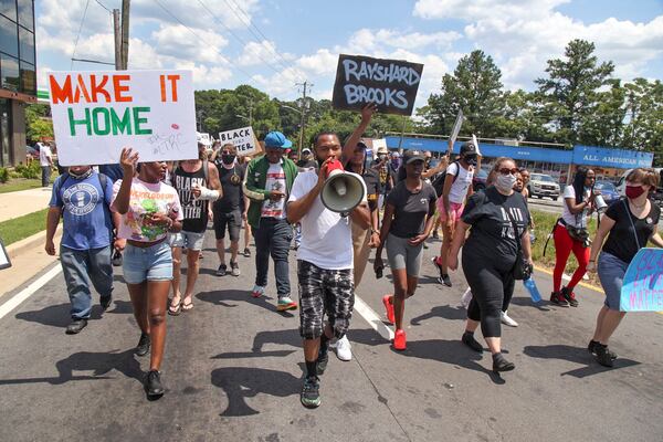  Protesters gather on University Avenue in Atlanta on Saturday  near the Wendy's where Rayshard Brooks, a 27-year-old black man,  was shot and killed by Atlanta police Friday evening during a struggle.  