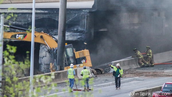 Crews began breaking up portions of I-85 Friday. JOHN SPINK / JSPINK@AJC.COM