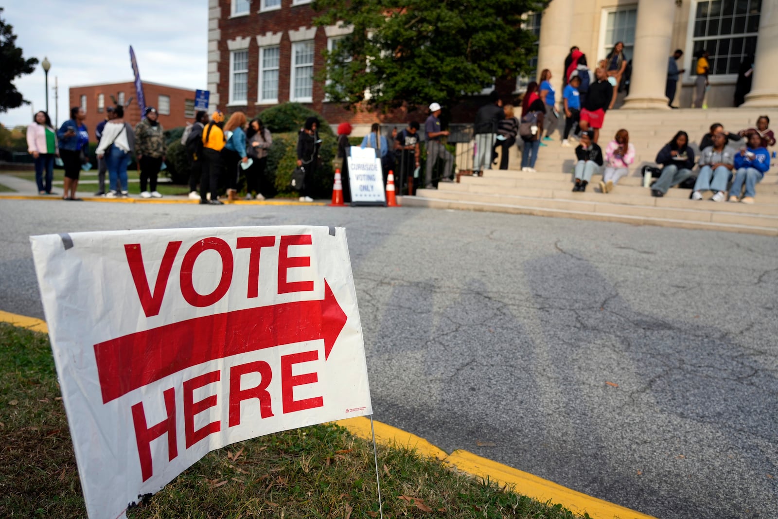 Students wait in a long line to vote outside the Dudley Building polling place during a get out the vote rally at North Carolina A&T in Greensboro, N.C., Monday, Oct. 28, 2024. (AP Photo/Chuck Burton)