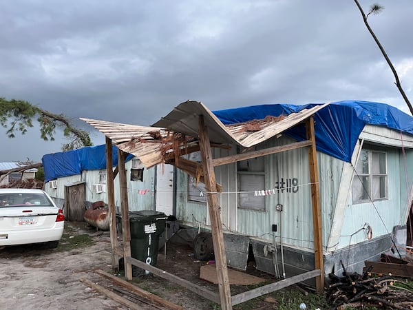 A trailer home with a tarp for a roof in a farmworker community in Lake Park, Georgia on Thursday, November 7, 2024.