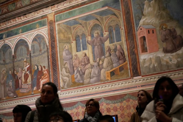 Visitors look at Giotto's frescoes inside St. Francis Basilica in Assisi, Italy, Saturday, March 1, 2025. (AP Photo/Gregorio Borgia)