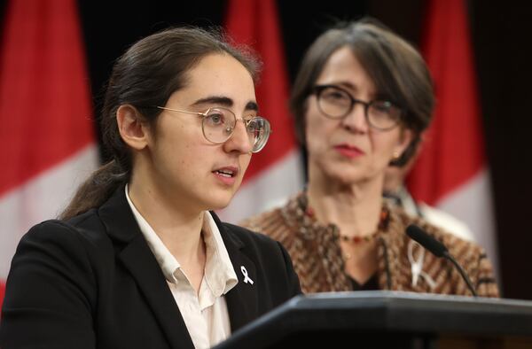 Director of legal affairs at the National Association of Women and the Law, Suzanne Zaccour, left, speaks at a press conference on new measures to strengthen gun control as gun control advocate and survivor of the 1989 Ecole Polytechnique massacre Nathalie Provost listens in Ottawa, Ontario, on Thursday, Dec. 5, 2024. (Patrick Doyle/The Canadian Press via AP)