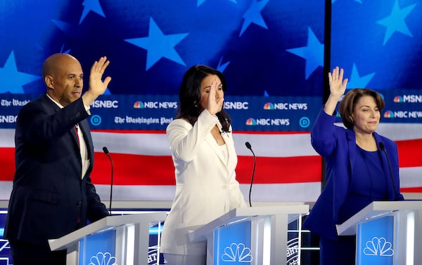 11/20/2019 -- Atlanta, Georgia -- (L to R) Senator Cory Booker, Representative Tulsi Gabbard, and Senator Amy Klobuchar all try to get the attention of the moderators, during the MSNBC/The Washington Post Democratic Presidential debate inside the Oprah Winfrey Soundstage at Tyler Perry Studios, Monday, November 20, 2019. (Alyssa Pointer/Atlanta Journal Constitution)