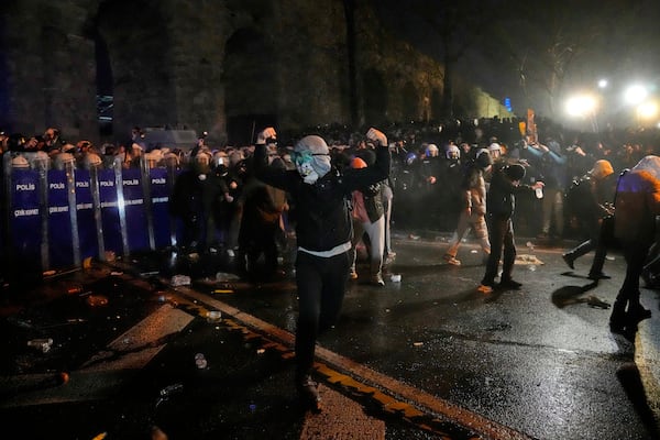 Police officers use pepper spray during clashes with people as they protest against the arrest of Istanbul's Mayor Ekrem Imamoglu, in Istanbul, Turkey, Friday, March 21, 2025. (AP Photo/Khalil Hamra)