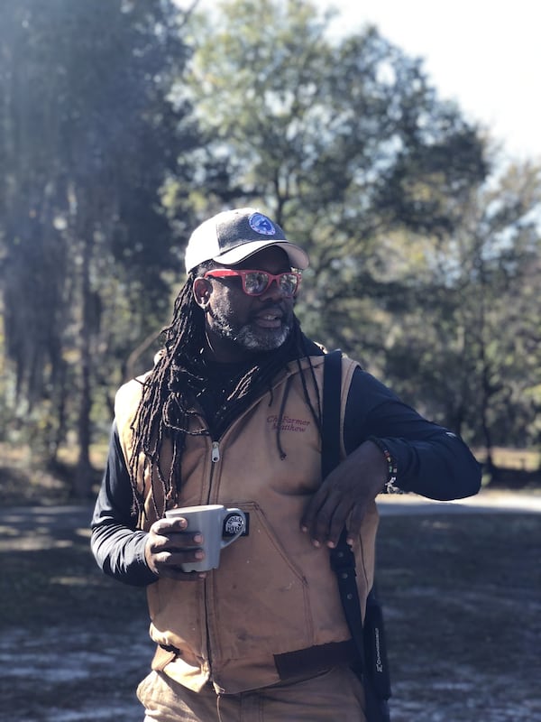 Walking through Where the Wild Things Are, a section of Gilliard Farms, chef Matthew Raiford sports a Mossberg in case he encounters snakes. CONTRIBUTED BY SANJEEV AND UMA CHATTERJEE