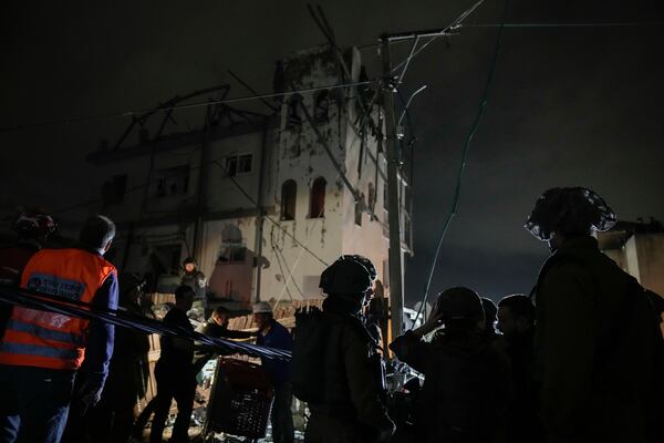 Security forces secure the area next to a building hit by a rocket fired from Lebanon in Shefa-Amr in northern Israel, on Monday, Nov. 18, 2024. A woman was killed and several others were injured medical officials said.(AP Photo/Leo Correa)