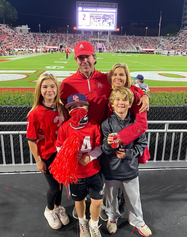 Former Georgia quarterback Cory Phillips and his wife Courtney, a former Gym Dawg, pose with their three children at at Sanford Stadium. (Family photo)