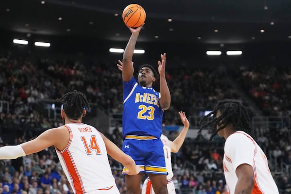 McNeese State guard Brandon Murray (23) takes a shot over Clemson defenders during the first half in the first round of the NCAA college basketball tournament, Thursday, March 20, 2025, in Providence, R.I. (AP Photo/Charles Krupa)