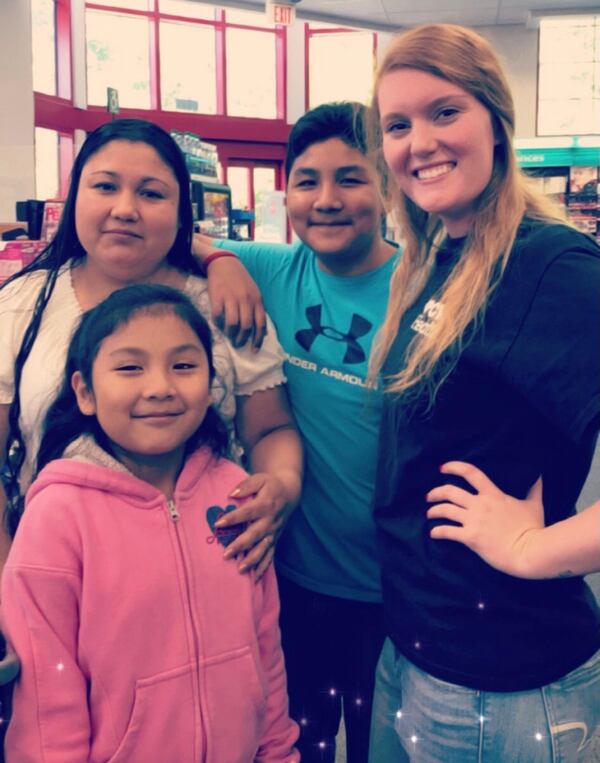 Oscar Junior Lorenso Ortiz, back and center, poses with his mother, younger sister and a family friend.