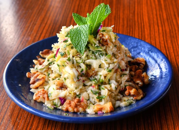 Chef Faik Usman's Salad of Cabbage, Mint and Walnuts, from Faik Usman, the chef-owner of Cafe Raik in Duluth, is a delicious way to use fall cabbage. Lemon and fresh mint make it fresh and clean tasting; chopped walnuts add a bit of crunch. (Styling by chef Faik Usman / Chris Hunt for the AJC)