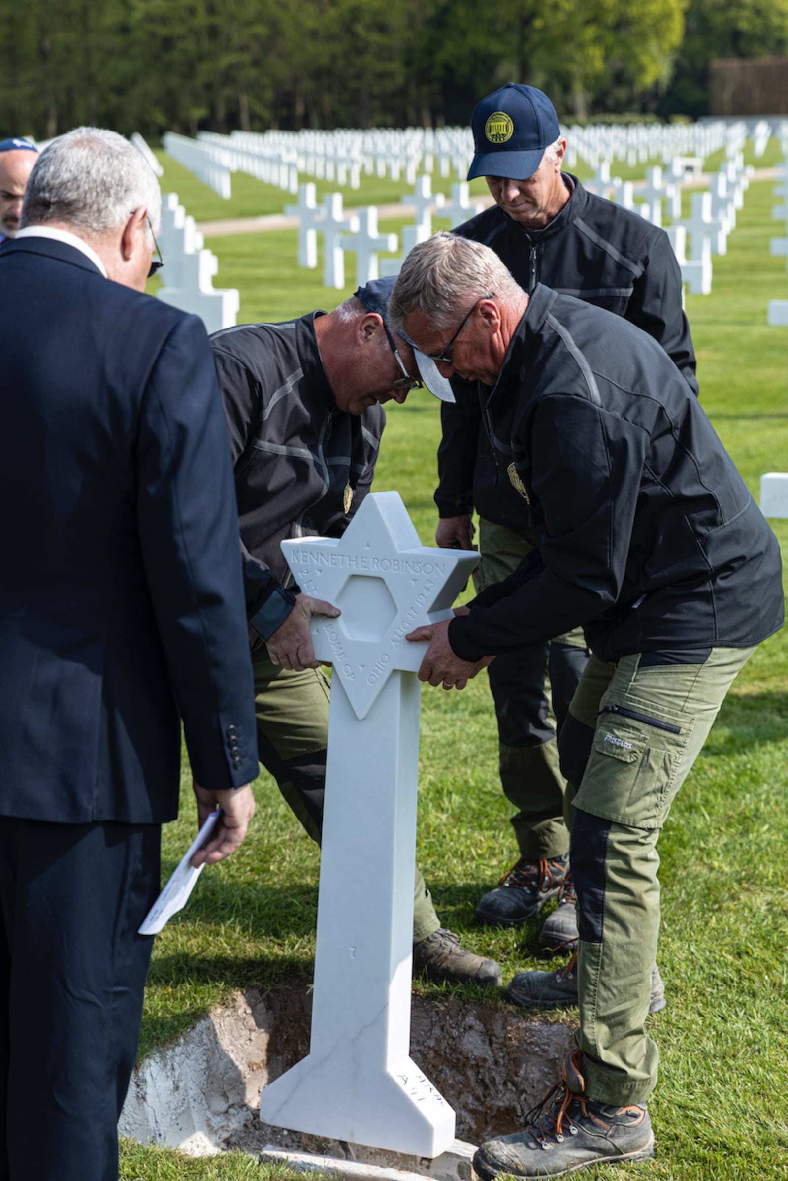 Workers replace a cross with a Star of David at a military cemetery. Photo: courtesy Operation Benjamin