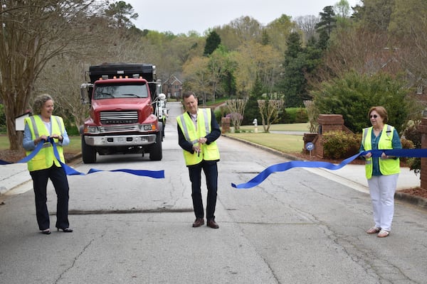 Tucker Mayor Frank Auman holds a socially distant ribbon-cutting ceremony last week to mark the city's 2020 SPLOST-funded road resurfacing campaign.