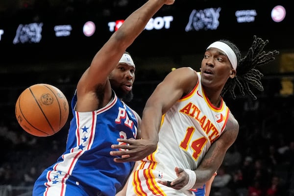 Atlanta Hawks guard Terance Mann (14) passes against Philadelphia 76ers forward Guerschon Yabusele (28) during the first half of an NBA basketball game, Monday, March 10, 2025, in Atlanta. (AP Photo/Mike Stewart)