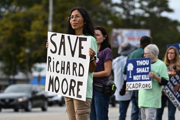 Protestors look on prior to the scheduled execution of Richard Moore, Friday, Nov. 1, 2024, outside of Broad River Correctional Institution in Columbia, S.C. (AP Photo/Matt Kelley)