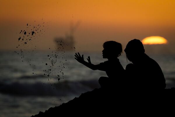 Youngsters play in the sand in Huntington Beach, California, during the pandemic.