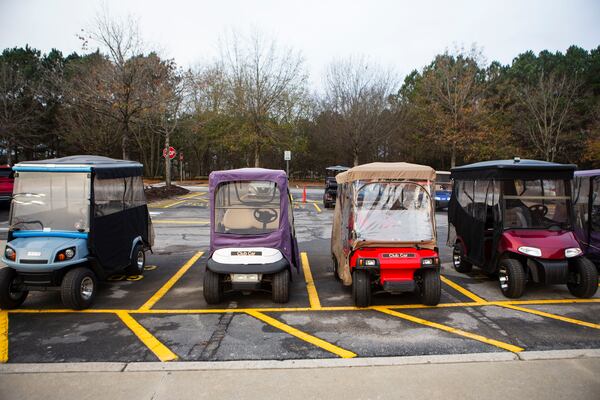 Golf carts parked during the re-opening of Walmart in Peachtree City, Georgia, on Wednesday, December 21, 2022. The store reopened after burning down in August 2022. CHRISTINA MATACOTTA FOR THE ATLANTA JOURNAL-CONSTITUTION.