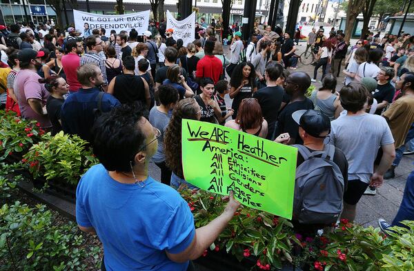 August 13, 2017 Atlanta: Suzanne Marks holds a sign for Heather Heyer as hundreds gather for a anti white nationalism memorial and march in response to violence in Virginia at Woodruff Park on Sunday, August 13, 2017, in Atlanta.    Curtis Compton/ccompton@ajc.com