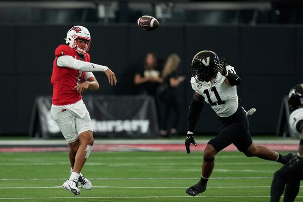 UNLV quarterback Jayden Maiava (1) throws against Vanderbilt defensive end Darren Agu (11) during the first half of an NCAA college football game Saturday, Sept. 16, 2023, in Las Vegas. (AP Photo/John Locher)