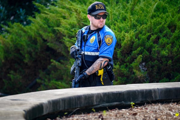 A KSU police officer stands watch outside the Austin Residence Complex following the deadly shooting at an apartment complex near campus. Ben Hendren for the AJC