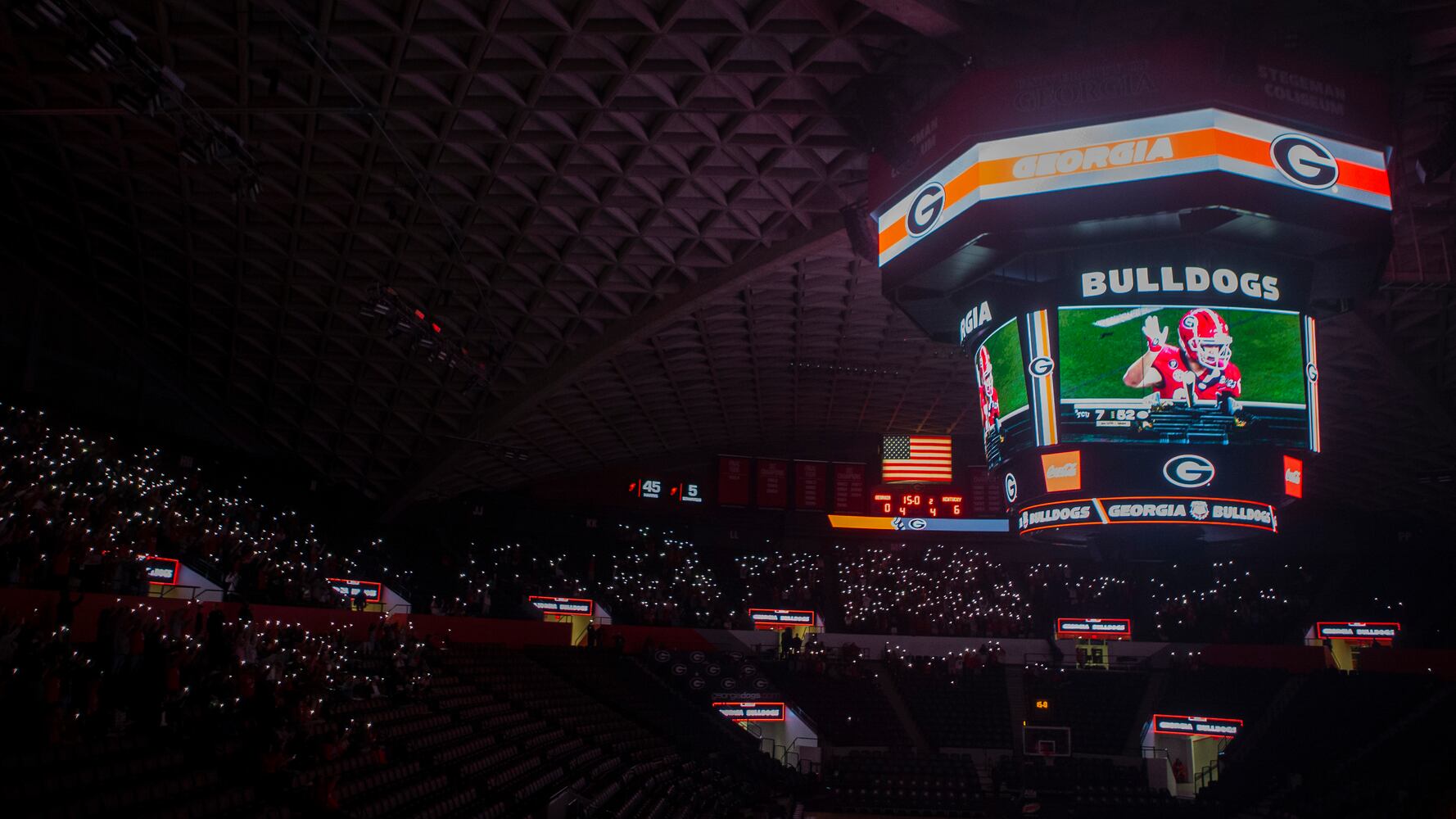 University of Georgia fans light up Stegeman Coliseum during the fourth quarter of the College Football Championship on Monday, January 9, 2023, at Stegeman Coliseum in Athens, Georgia. The University of Georgia defeated the Texas Christian University football team 65-7. CHRISTINA MATACOTTA FOR THE ATLANTA JOURNAL-CONSTITUTION.