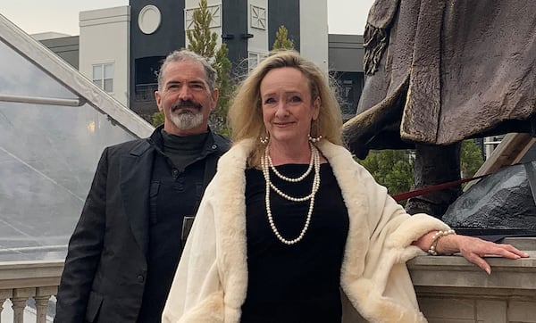 Sculptors Stan Mullins and Kathy Fincher pose at the base of a life-sized replica of the statue of Martin Luther King, Jr. at the annual Asa Candler Awards Gala at the Millennium Gate Museum. The positive feedback from the event launched the creation of the full-scale bronze statue that will be unveiled at Rodney Cook Sr. Peace Park this weekend. (Courtesy of Kathy Fincher) 