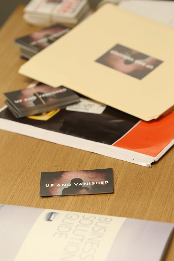 Business cards for Payne Lindsey’s podcast, “Up and Vanished,” lie on his desk in his small office in Ponce City Market in Atlanta. The podcast, begun last summer, delves into the 2005 disappearance of Ocilla school teacher Tara Grinstead. HENRY TAYLOR / HENRY.TAYLOR@AJC.COM