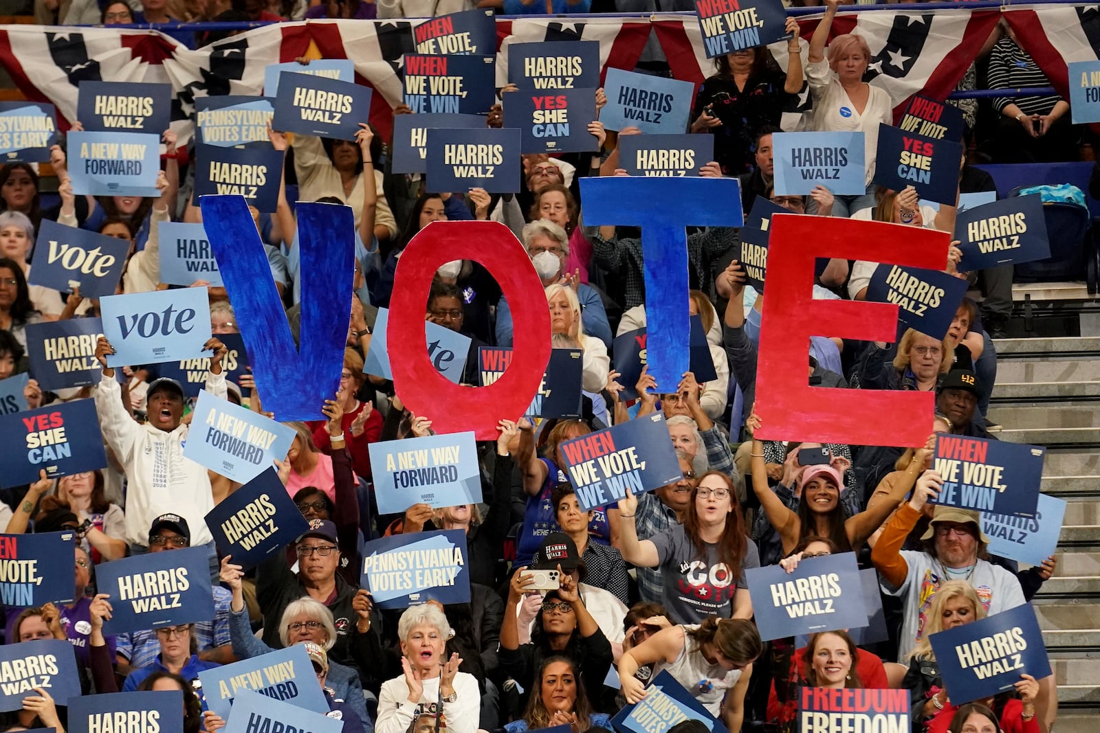 Attendees at a rally in Pennsylvania hold signs in support of Vice President Kamala Harris.