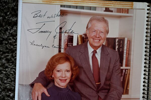 In a  scrapbook, Sally Hollis keeps this signed photo of Jimmy and Rosalynn Carter. (Hyosub Shin / Hyosub.Shin@ajc.com)